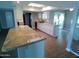 Kitchen featuring granite island, white cabinetry, and stainless steel appliances in an open-concept layout at 10116 W Bolivar Dr, Sun City, AZ 85351