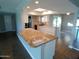 Kitchen island with granite countertops, white cabinetry, open concept and stainless appliances at 10116 W Bolivar Dr, Sun City, AZ 85351