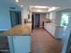 Bright kitchen with granite island, white cabinets, stainless appliances and wood-look floors at 10116 W Bolivar Dr, Sun City, AZ 85351
