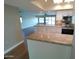 Open kitchen with island, granite countertops, white cabinetry, and stainless steel appliances at 10116 W Bolivar Dr, Sun City, AZ 85351