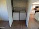 Convenient laundry closet with washer, dryer, and overhead storage, located near the kitchen at 10116 W Bolivar Dr, Sun City, AZ 85351
