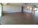 Large living room featuring wood-look floors, ceiling fan, and a view of kitchen at 10116 W Bolivar Dr, Sun City, AZ 85351