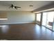 Living room features wood flooring and patio access through sliding glass doors at 10116 W Bolivar Dr, Sun City, AZ 85351