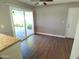 The open living space has wood look floors, a ceiling fan, and sliding doors to the patio at 10116 W Bolivar Dr, Sun City, AZ 85351