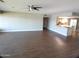 Open living room features wood floors and a kitchen bar for easy entertaining at 10116 W Bolivar Dr, Sun City, AZ 85351