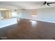 Open living room features wood floors, kitchen bar, and large mirrored wall at 10116 W Bolivar Dr, Sun City, AZ 85351