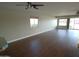 Open-concept living area with ceiling fan and sliding glass doors to backyard at 10116 W Bolivar Dr, Sun City, AZ 85351