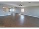 Bright living room with modern ceiling fan and wood-look floors at 10116 W Bolivar Dr, Sun City, AZ 85351