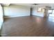 Large living room with wood look floors, large windows, and open floor plan at 10116 W Bolivar Dr, Sun City, AZ 85351