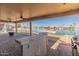 Covered patio boasts a built-in bar, perfect for entertaining with scenic waterfront views at 10116 W Bolivar Dr, Sun City, AZ 85351