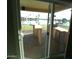Covered patio with outdoor kitchen and lake view, perfect for entertaining at 10116 W Bolivar Dr, Sun City, AZ 85351