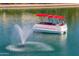 Red and white pontoon boat is parked on a beautiful sunny day in the lake at 10116 W Bolivar Dr, Sun City, AZ 85351