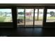 Patio view through sliding glass doors showcases a tranquil backyard with waterfront access at 10116 W Bolivar Dr, Sun City, AZ 85351
