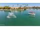 Beautiful waterfront homes are surrounded by palm trees and crystal clear lake water at 10116 W Bolivar Dr, Sun City, AZ 85351