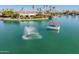 Beautiful waterfront homes are surrounded by palm trees and crystal clear lake water at 10116 W Bolivar Dr, Sun City, AZ 85351