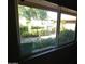 Sunlight streams through this window overlooking a beautiful backyard garden at 10116 W Bolivar Dr, Sun City, AZ 85351
