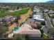 Expansive aerial view of a luxury home with a pool, golf course access, and desert landscaping at 10125 N 78Th Pl, Scottsdale, AZ 85258