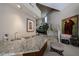 Stylish bar area with granite counters, seating, and views of the staircase at 10125 N 78Th Pl, Scottsdale, AZ 85258