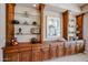 Close-up of custom-built wooden shelves with glass displays at 10125 N 78Th Pl, Scottsdale, AZ 85258