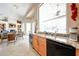 Well-appointed kitchen with granite countertops, light wood cabinets, and a view to an adjacent living area at 10125 N 78Th Pl, Scottsdale, AZ 85258