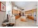 Bright, open kitchen with light wood cabinetry, granite counters, tile floors, and modern appliances at 10125 N 78Th Pl, Scottsdale, AZ 85258