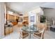 Open kitchen with a central island, tile floors, and a glass table with seating for a cozy dining experience at 10125 N 78Th Pl, Scottsdale, AZ 85258