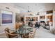 Open-concept living room features a fireplace, built-in shelving, and a glass table with a stunning aesthetic at 10125 N 78Th Pl, Scottsdale, AZ 85258