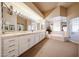 Bright bathroom featuring double sinks, vanity lighting, and a large soaking tub at 10125 N 78Th Pl, Scottsdale, AZ 85258