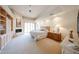 Large main bedroom with a fireplace, private patio access, and custom built-in shelving at 10125 N 78Th Pl, Scottsdale, AZ 85258