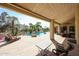 Resort-style pool area featuring a covered patio, outdoor seating, lush landscaping, and a sparkling swimming pool at 10125 N 78Th Pl, Scottsdale, AZ 85258