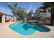 Spacious backyard with a sparkling pool, surrounded by lush greenery and comfortable seating areas, ideal for outdoor living at 10125 N 78Th Pl, Scottsdale, AZ 85258