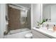 Well-lit bathroom featuring a sleek, modern vanity and tiled shower with glass doors at 11673 N 136Th St # 1005, Scottsdale, AZ 85259
