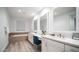 Bright bathroom with dual vanities, modern fixtures, large mirrors, and soaking tub at 11673 N 136Th St # 1005, Scottsdale, AZ 85259