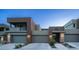 Striking exterior shot of modern townhomes showcases clean lines, private garages, and manicured landscaping at 11673 N 136Th St # 1005, Scottsdale, AZ 85259