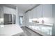 Bright kitchen features stainless steel appliances, sleek white cabinets, quartz countertops, and recessed lighting for a modern look at 11673 N 136Th St # 1005, Scottsdale, AZ 85259