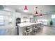 Modern kitchen boasts white cabinets, stainless steel appliances, quartz countertops, and eye-catching red pendant lighting at 11673 N 136Th St # 1005, Scottsdale, AZ 85259