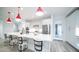 Bright kitchen with a large island, white cabinets, stainless appliances, and modern pendant lights for stylish meal preparation at 11673 N 136Th St # 1005, Scottsdale, AZ 85259