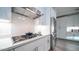 Gourmet kitchen featuring stainless steel appliances, sleek white cabinets, and a gas cooktop set against a bright white countertop at 11673 N 136Th St # 1005, Scottsdale, AZ 85259