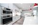 Bright kitchen features Bosch stainless steel appliances and sleek white cabinets, offering a clean, contemporary cooking space at 11673 N 136Th St # 1005, Scottsdale, AZ 85259