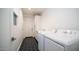 Bright laundry room with modern appliances and a contrasting black and white tiled floor at 11673 N 136Th St # 1005, Scottsdale, AZ 85259