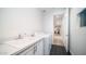 Well-lit laundry room featuring white appliances, a countertop sink, and a hexagon-tiled floor at 11673 N 136Th St # 1005, Scottsdale, AZ 85259