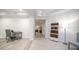 Office view highlighting an adjacent hallway, featuring modern tile and a bookshelf at 11673 N 136Th St # 1005, Scottsdale, AZ 85259