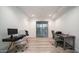Bright and airy office space featuring wood flooring, dual desks, and natural lighting at 11673 N 136Th St # 1005, Scottsdale, AZ 85259