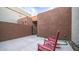 Private patio with red rocking chairs, small accent table, and gate access to the home at 11673 N 136Th St # 1005, Scottsdale, AZ 85259