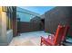 Cozy outdoor patio space complete with red rocking chairs and modern desert landscaping at 11673 N 136Th St # 1005, Scottsdale, AZ 85259