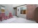Inviting patio with red rocking chairs and an accent table, creating a cozy outdoor living space at 11673 N 136Th St # 1005, Scottsdale, AZ 85259