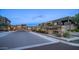 Exterior shot of modern community entrance with stone signage and lush desert landscaping at dusk at 11673 N 136Th St # 1005, Scottsdale, AZ 85259