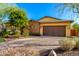 Charming single-story home featuring stone accents and well-manicured landscaping at 12034 W Red Hawk Dr, Peoria, AZ 85383