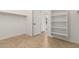 Empty walk-in closet with white shelving and tile flooring provides ample storage at 12034 W Red Hawk Dr, Peoria, AZ 85383