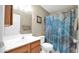Bathroom featuring a shower with blue curtain, a wood vanity and a mirror at 1222 W Baseline Rd # 114, Tempe, AZ 85283